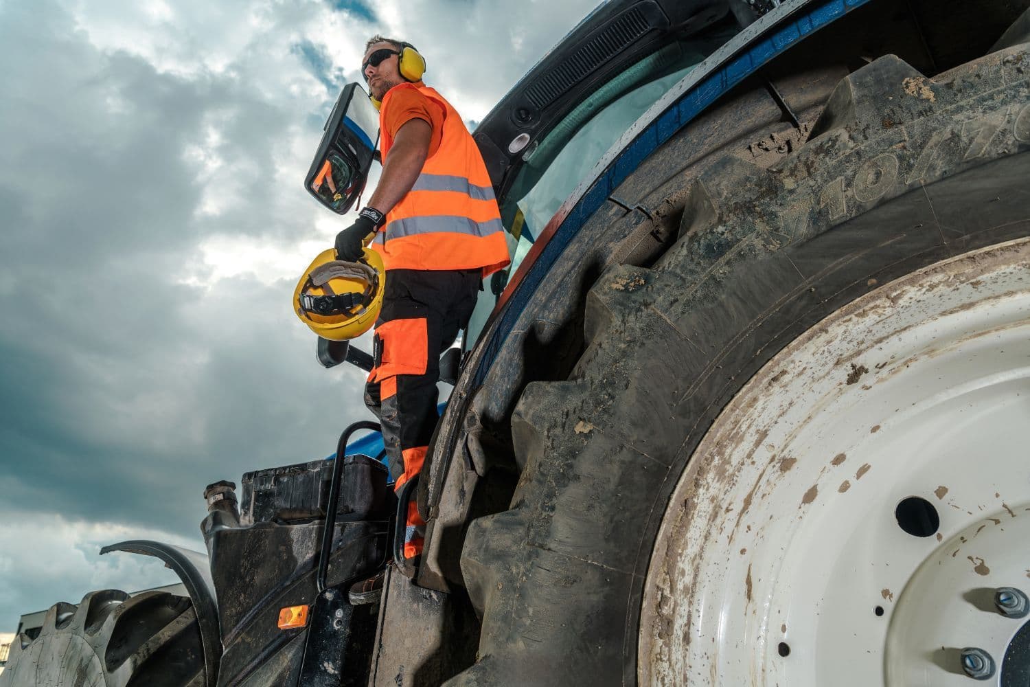 man in safety gear on tractor